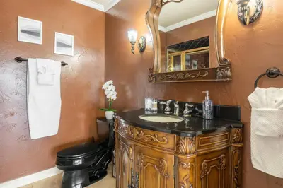a bathroom with a wooden sink and a mirror at Majestic Anaheim Panorama Hill Home With Sunset in Anaheim