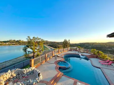 a swimming pool with a view of the water at Stunning Panoramic Waterfront Pool Home Escape in Anaheim