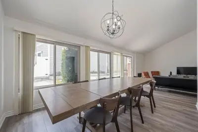 a dining room with a large wooden table and chairs at Elm Mountain View Fire pit, quiet and more in Los Angeles