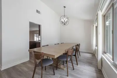 a dining room with a wooden table and chairs at Elm Mountain View Fire pit, quiet and more in Los Angeles
