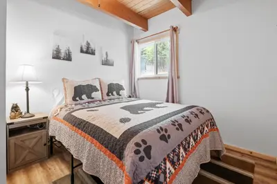 a bedroom with a bed and a window at Chateau Rouge - Walk to Lake & Village, AC, Pet Friendly! in Big Bear Lake