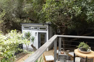 a small shed with a door and a table at Zen Birds Nest of Topanga Boho Chic with Epic Deck in Topanga