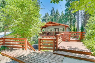 a wooden deck with a gazebo in a forest at 1 Mi to Lake Crestline Cabin with Deck and Gas Grill! in Crestline