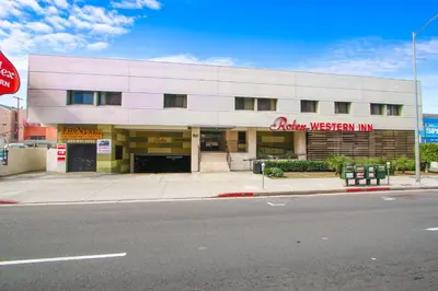 a building on the corner of a street at Rotex Western Inn in Los Angeles