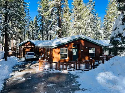 a log cabin in the woods in the snow at Château Bouli - 4 Season Escape and Games Room in Big Bear Lake