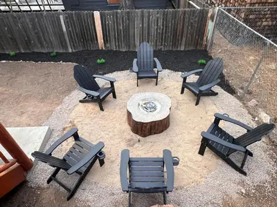 a group of chairs and a table and a tree stump at Château Bouli - 4 Season Escape and Games Room in Big Bear Lake