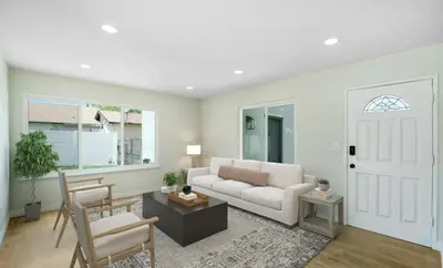 a living room with a white couch and a table at Lancaster Pool Home in Lancaster
