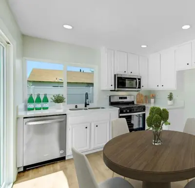 a white kitchen with a wooden table and a dining room at Lancaster Pool Home in Lancaster