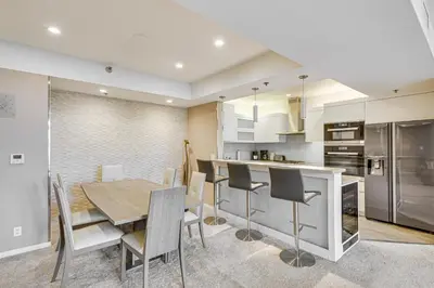 a kitchen and dining room with a table and chairs at 2 Mi to Hollywood Condo with Pool and Hot Tub Access in Los Angeles