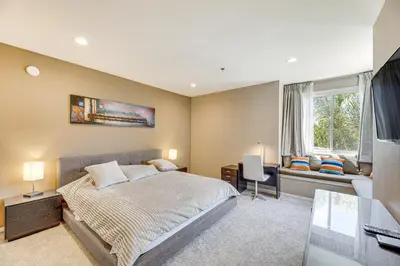 a bedroom with a bed and a television and a window at 2 Mi to Hollywood Condo with Pool and Hot Tub Access in Los Angeles
