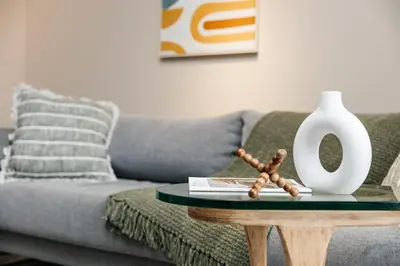 a living room with a couch and a table with a vase at Gorgeous studio steps from The Groove in Los Angeles