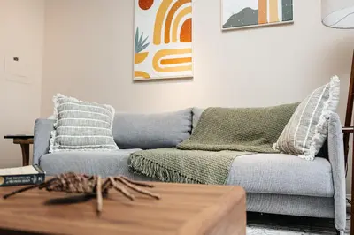 a living room with a couch and a coffee table at Gorgeous studio steps from The Groove in Los Angeles