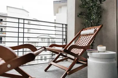 a chair on a balcony with a view of a city at Gorgeous studio steps from The Groove in Los Angeles