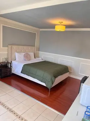 a bedroom with a bed with a green blanket at Studio Living,Quiet Neighborhood, Near Airport in Walnut