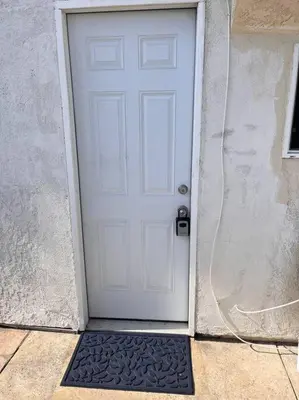 a white door with a black mat in front of it at Studio Living,Quiet Neighborhood, Near Airport in Walnut