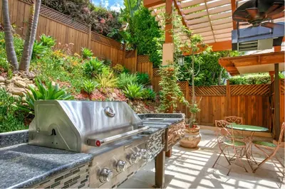 a outdoor kitchen with a grill on a patio at Skyhill Oasis New Lux Designer Modern in Los Angeles