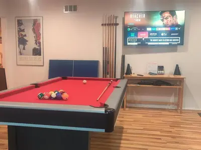 a room with a pool table and a tv at Skyhill Pool - Walk to Universal - Resort-Style Home in Los Angeles