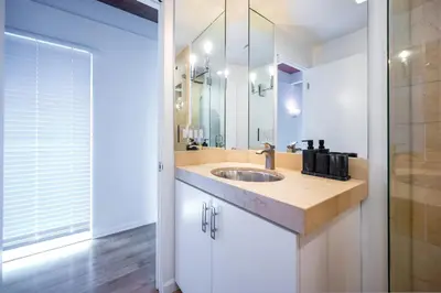 a bathroom with a sink and a mirror at Hollywood Hills Retreat with Panoramic View in Los Angeles