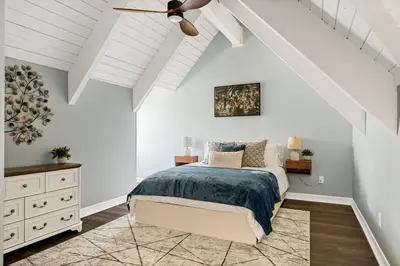 a bedroom with a bed and a ceiling fan at Oak Mountain Retreat, Hot Tub, & BBQ, Game Room! in Lake Arrowhead