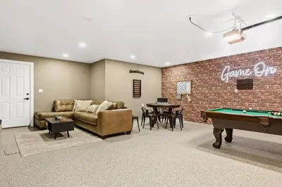 a living room with a couch and a pool table at Oak Mountain Retreat, Hot Tub, & BBQ, Game Room! in Lake Arrowhead