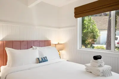 a bedroom with a white bed and a window at Scout's Lakehouse Retreat by Colby & Conrad in Lake Arrowhead