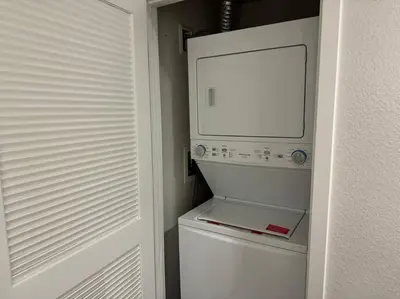 a white washer and dryer in a small kitchen at Modern and Lavish apartment in Glendale