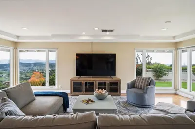 a living room with a couch and a flat screen tv at Bouquet Cottage home in Thousand Oaks