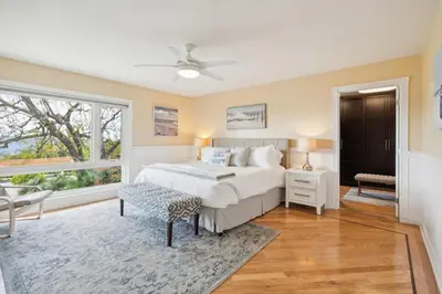 a bedroom with a large bed and a window at Bouquet Cottage home in Thousand Oaks