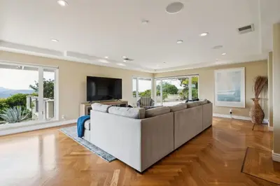 a living room with a large couch and a tv at Bouquet Cottage home in Thousand Oaks