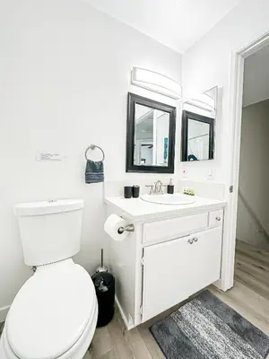a white bathroom with a toilet and a sink at Charming 2-BR, 2-Story Retreat in Heart of LA - BR4 in Los Angeles