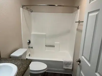 a white bathroom with a toilet and a sink at Travel Haven at Miracle Mile- 110 in Los Angeles