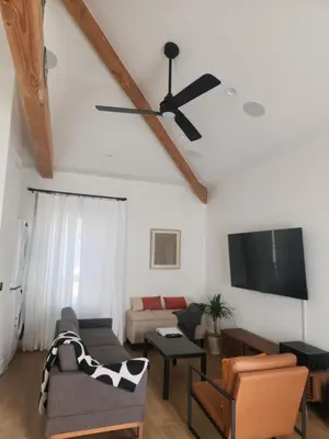 a living room with a ceiling fan and a couch at Ladera Retreat near Sofi Stadium, LAX, Beach in Los Angeles