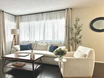 a living room with a white couch and a table at The Nest Manhattan Beach, Partial Ocean View in Los Angeles