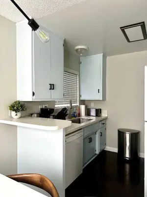 a kitchen with white cabinets and a sink at The Nest Manhattan Beach, Partial Ocean View in Los Angeles