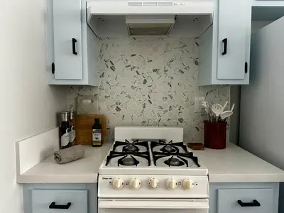 a white stove top oven in a kitchen at The Nest Manhattan Beach, Partial Ocean View in Los Angeles