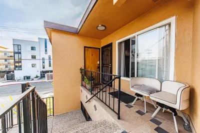 a balcony with a chair and a window at Gorgeous 1 Bedroom Apartment#7 in Los Angeles