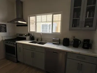 a kitchen with a sink and a stove and a window at Green House in Los Angeles