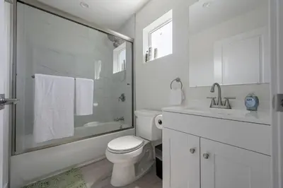 a white bathroom with a toilet and a sink at Prime new beautiful studio in burbank in Burbank