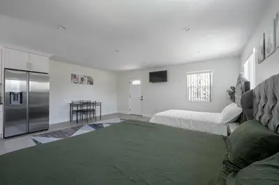 a living room with a couch and a refrigerator at Prime new beautiful studio in burbank in Burbank