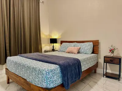 a bedroom with a bed with a blue comforter at New Renovated House in Little Saigon in Midway City