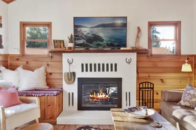 a living room with a fireplace and a couch at The Nest On Towne Trail - Hot Tub, BBQ, Fire Pit in Big Bear Lake