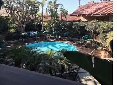 a view of a swimming pool with chairs and umbrellas at Beautiful Resort in Harbortown Point 1BD near Marina Park in Ventura