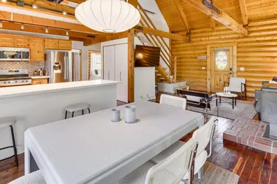 a kitchen and dining room with a white table and chairs at Community Pool Modern Cabin in Pine Mountain Club in Pine Mountain Club