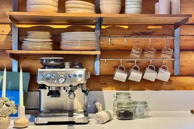 a kitchen counter with a coffee maker and cups at Community Pool Modern Cabin in Pine Mountain Club in Pine Mountain Club