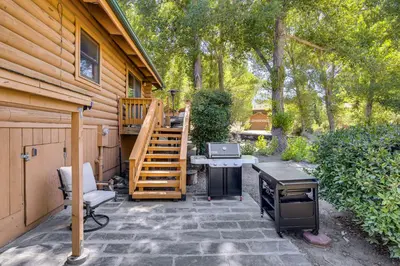 a patio with a desk and a staircase next to a house at Community Pool Modern Cabin in Pine Mountain Club in Pine Mountain Club