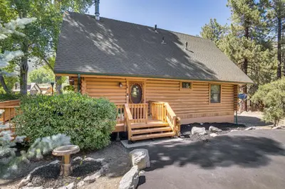 a log cabin with a porch and a deck at Community Pool Modern Cabin in Pine Mountain Club in Pine Mountain Club