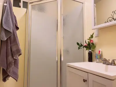 a bathroom with a shower and a white sink at private & Quiet unit D Bed & bath in Rosemead