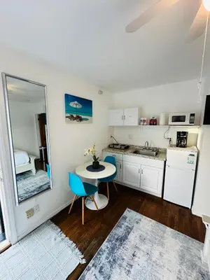 a small kitchen with a table and a mirror at Studio, 5 minutes to Venice Beach Free Parking! in Los Angeles