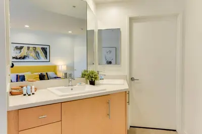 a bathroom with a sink and a mirror at Lavish Living Lux Marina Views in Los Angeles
