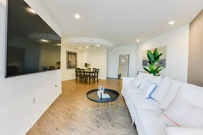 a living room with a white couch and a table at Lavish Living Lux Marina Views in Los Angeles